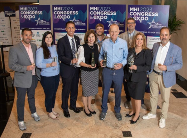 Large group holding awards and posing